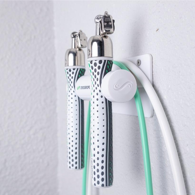Get Lean + Get Strong Wall Mounts Jump rope wall mount secured to the wall holding the Get Lean Set from Crossrope.