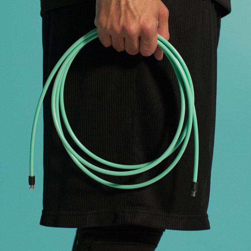 1/4 LB Jump Rope Person holding coiled 1/4 LB rope no handles