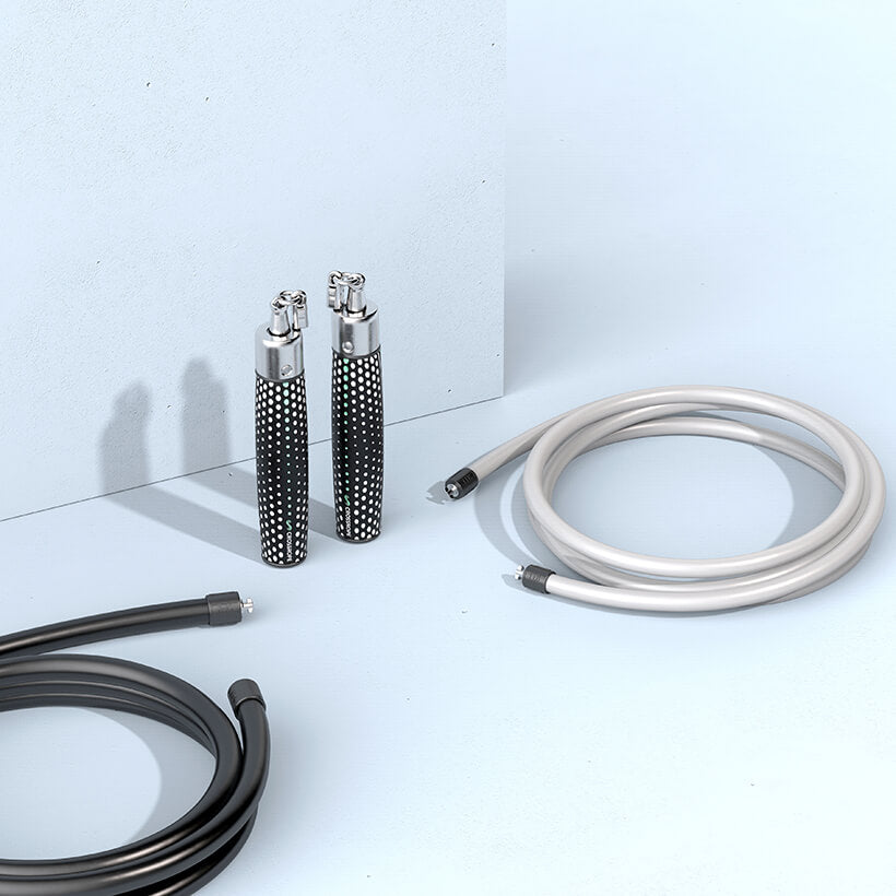Get Strong V1 (Like-new) Power Handles standing vertically on the floor with a 1 LB and 2 LB jump rope coiled beside them