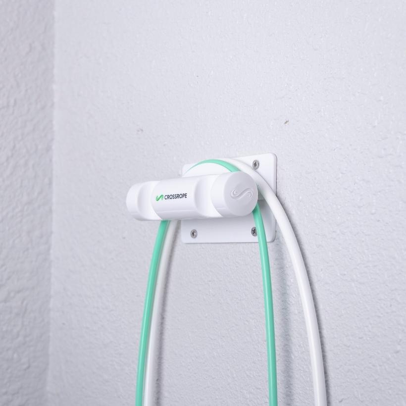 Get Lean Wall Mount Jump rope wall mount secured to the wall holding the 1/4 and 1/2 pound jump ropes from Crossrope.