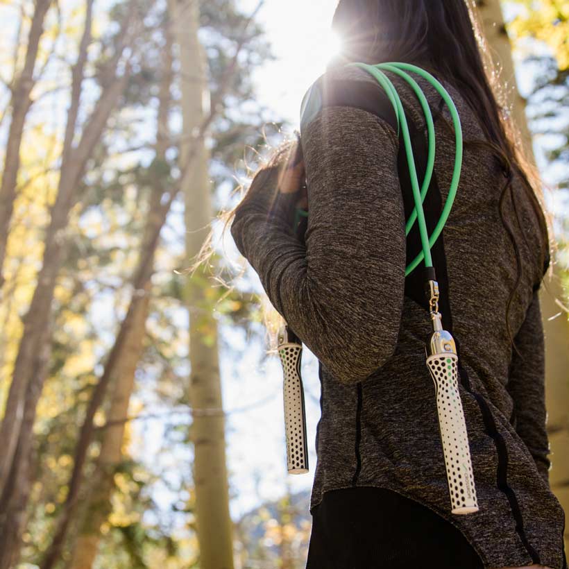 Slim Handles (2022) Woman holding Slim Handles (2020) with the 1/4 LB Jump Rope