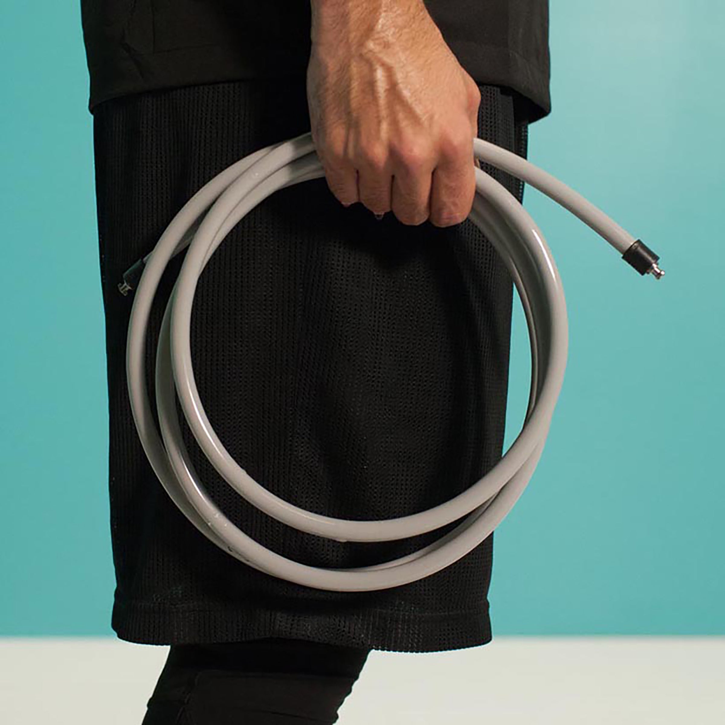 1 LB Heavy Rope Person holding a coiled gray 1 LB jump rope against a teal background