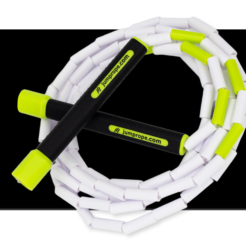 Beaded Rope White jump rope with green handles on a black background