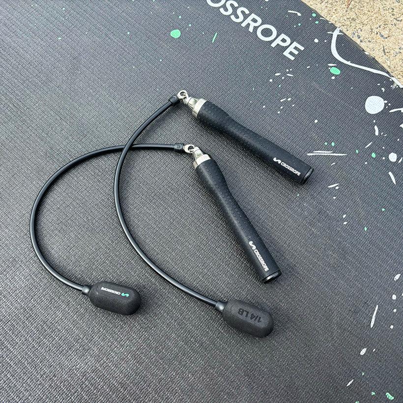 Ropeless One Black (ropeless) jump rope on a gray mat with 'Crossrope' branding.