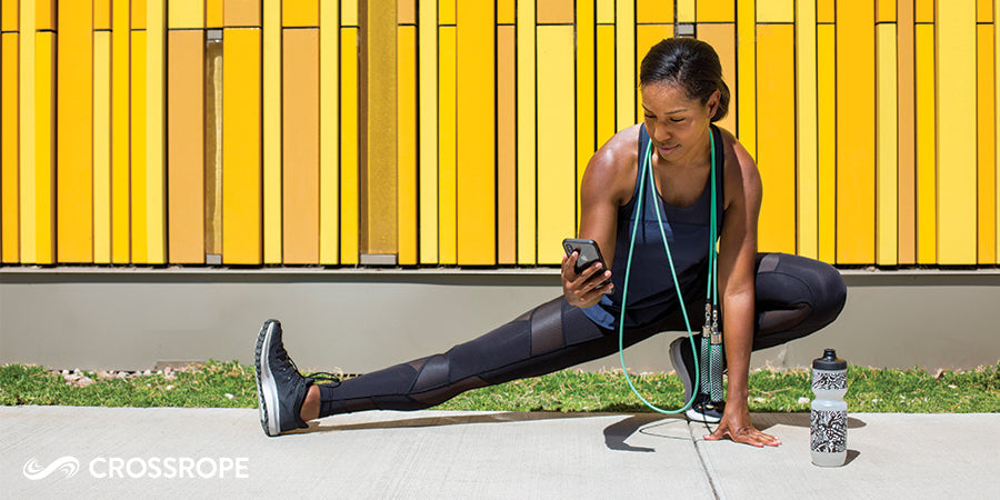woman stretching outside to warm up before jumping rope to avoid injuries and shin splints