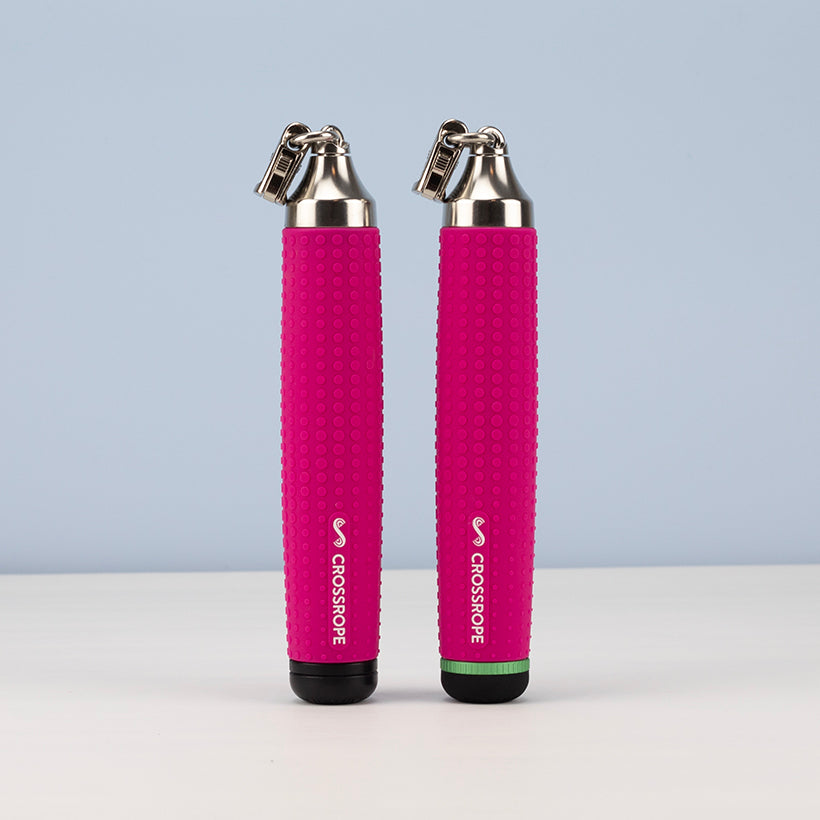 Ropeless AMP Vibe Set (LE) Two pink jump rope handles with silver connectors on a light blue background