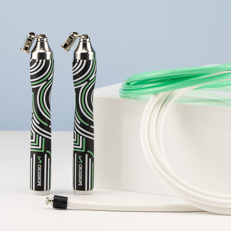 Two Crossrope slim handles with 1/4 LB and 1/2 LB jump ropes on a blue and white background