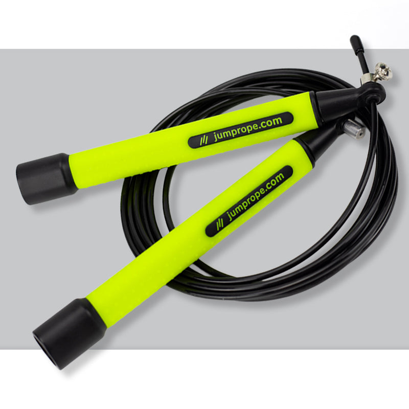 Jump rope with neon green handles and black cable on a light gray background