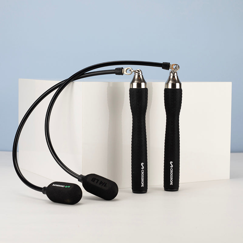 Black Ropeless jump rope attachments permenantly connected to handles on a blue and white background