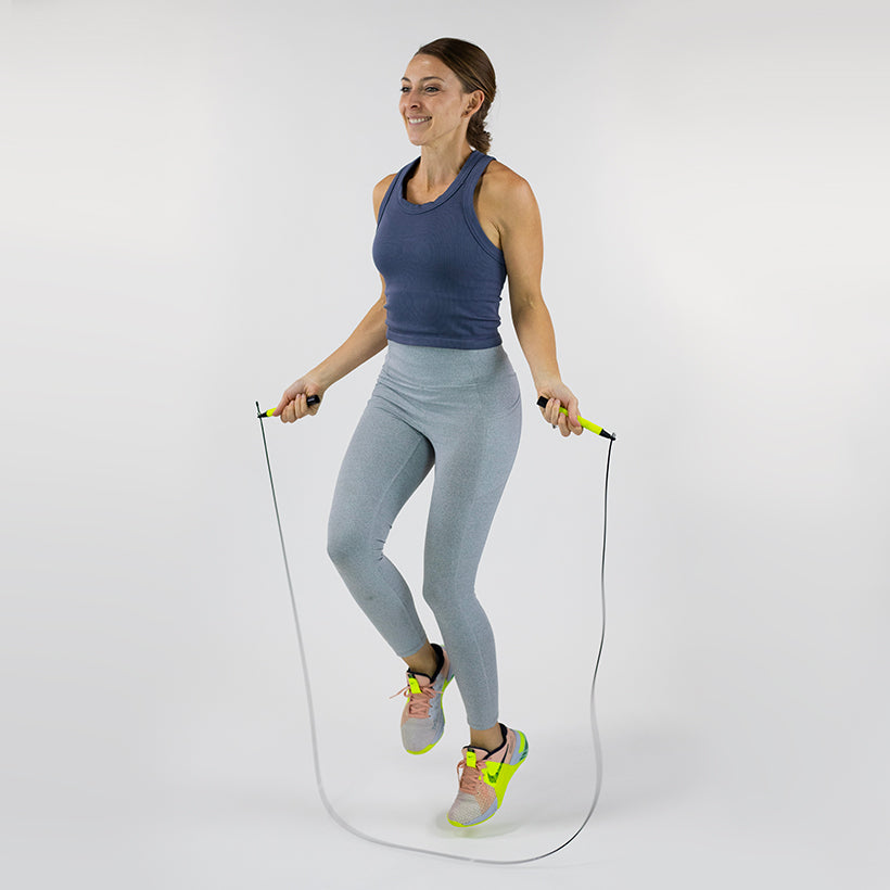 Speed Rope Woman jumping with a speed rope on a white background