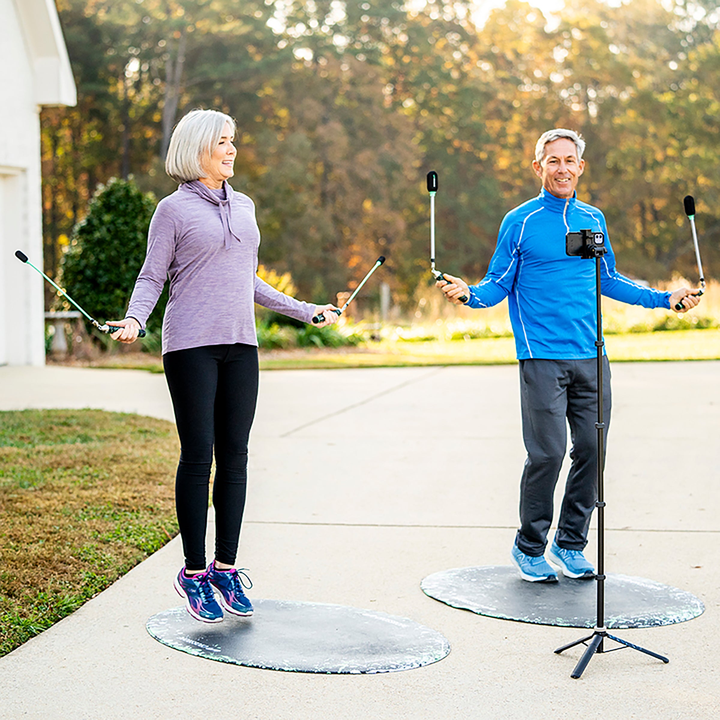 Jump Rope Mat (Splash) Two elderly people jumping with Crossrope Ropeless outdoors on jump rope mats