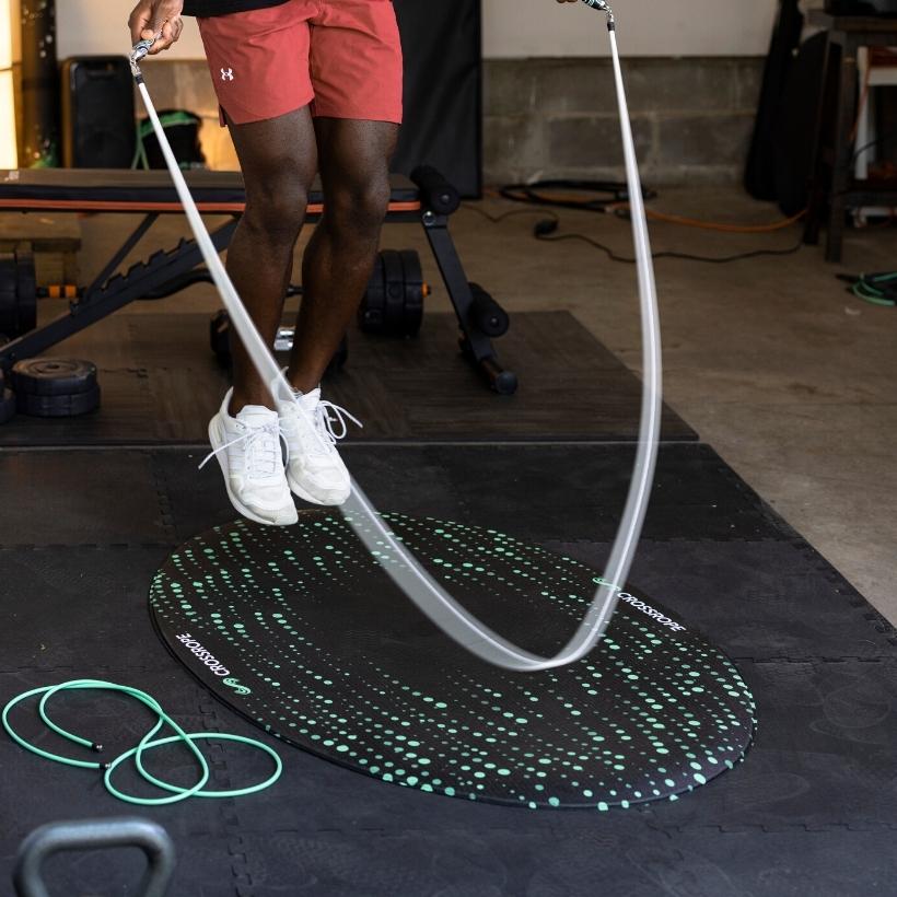 Jump Rope Mat (Flow) Person jumping rope in the garage on the new Crossrope Jump Rope Mat.