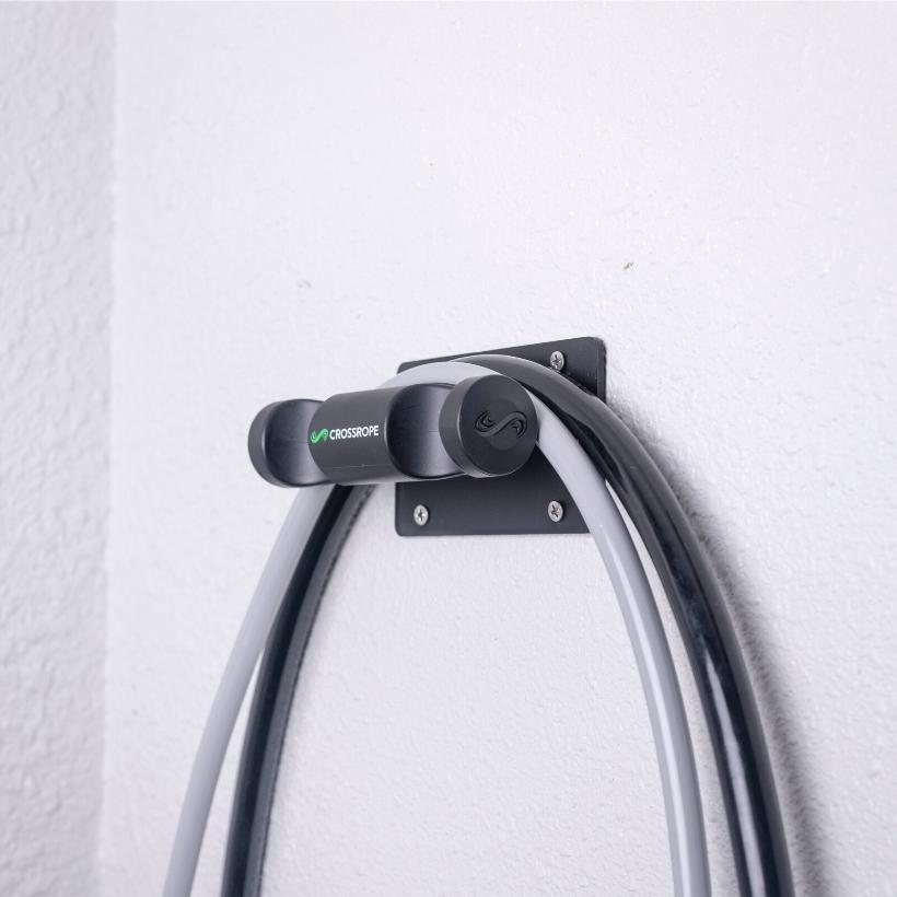 Get Strong Wall Mount Jump rope wall mount secured to the wall holding the 1 and 2 pound ropes from Crossrope.