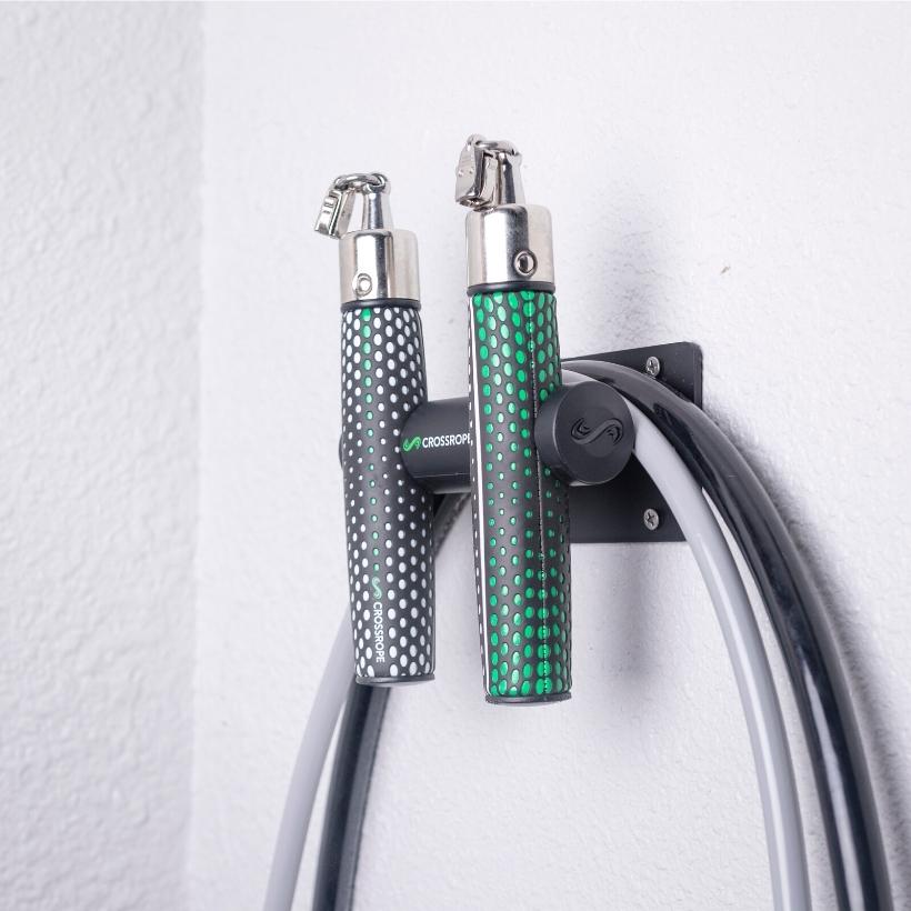 Get Strong Wall Mount Jump rope wall mount secured to the wall holding the Get Strong Set from Crossrope.