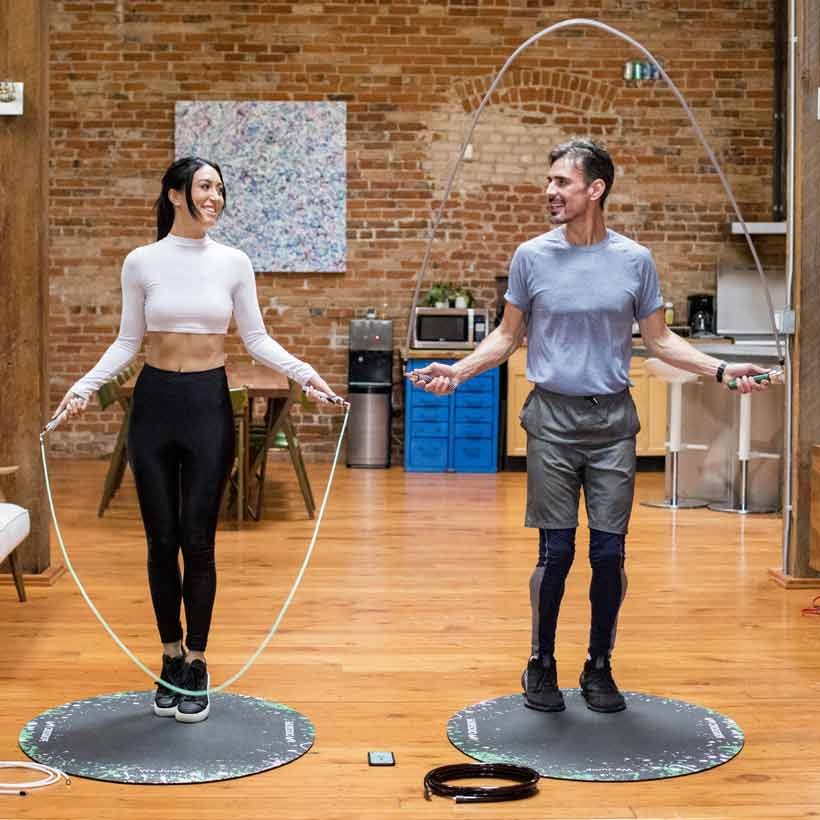 Secret Bundle Woman and man jumping with Crossrope jump ropes on a jump rope mat